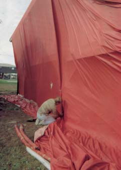person working on fumigation tent