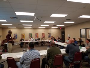 Image of training class seated at table arranged in a U shape 